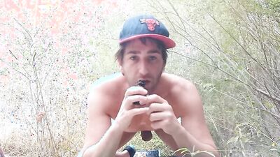 Kinky dude strips naked in nature and uses various dildos
