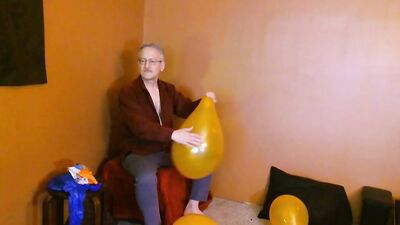 Amateur grandpa is playing with a balloon in his solo performance