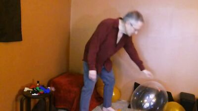 Amateur grandpa is playing with a balloon in his solo performance