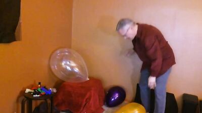 Amateur grandpa is playing with a balloon in his solo performance