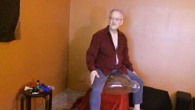 Amateur grandpa is playing with a balloon in his solo performance