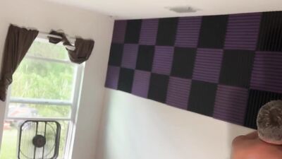 Fat guy films himself naked putting sound insulation in a room