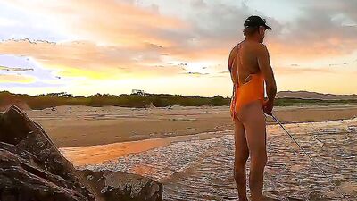 Orange one piece swimsuit down at the beach