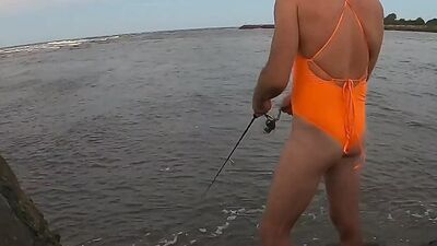 Orange one piece swimsuit down at the beach