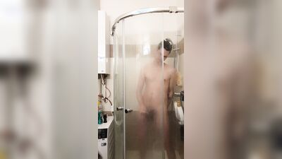 Cute gay bloke is masturbating while taking a hot shower