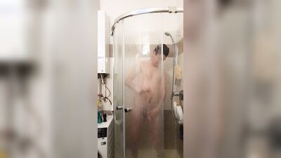 Cute gay bloke is masturbating while taking a hot shower