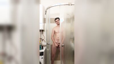 Cute gay bloke is masturbating while taking a hot shower