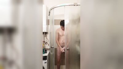 Cute gay bloke is masturbating while taking a hot shower
