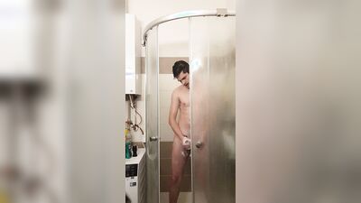 Cute gay bloke is masturbating while taking a hot shower
