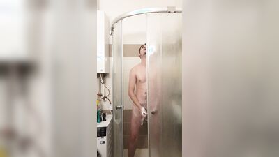 Cute gay bloke is masturbating while taking a hot shower