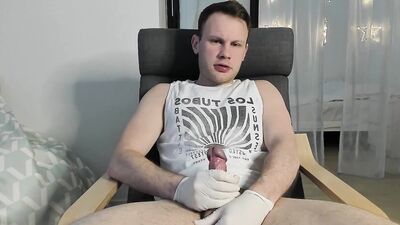 Mark Kimura is stroking his big dick with the gloves