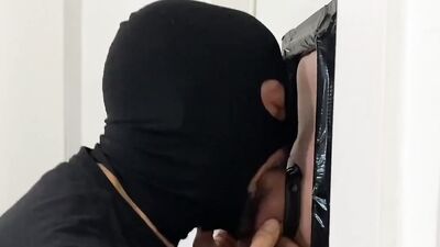 Masked man passionately sucks that hard cock thorough a gloryhole