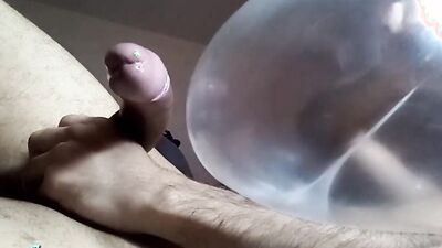 Naughty guy uses blown-up condom to play with his cock