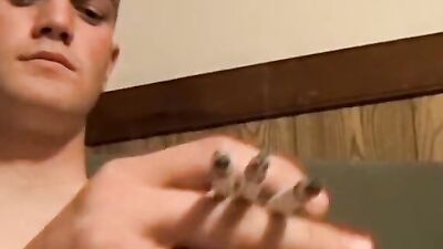Bryce Corbin is smoking a cigar while polishing his cock