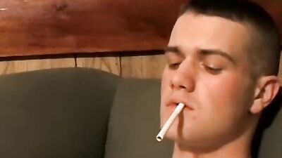 Bryce Corbin is smoking a cigar while polishing his cock