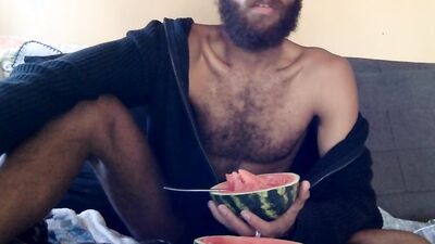 Hairy guy eats a watermelon wearing nothing but sexy robes