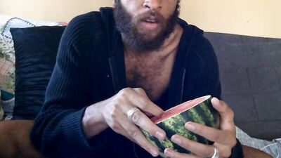 Hairy guy eats a watermelon wearing nothing but sexy robes