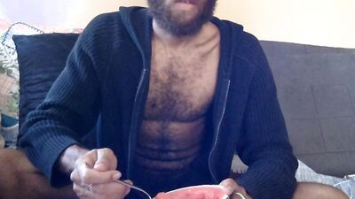 Hairy guy eats a watermelon wearing nothing but sexy robes