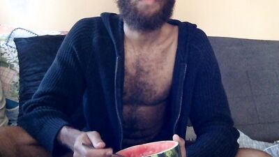 Hairy guy eats a watermelon wearing nothing but sexy robes