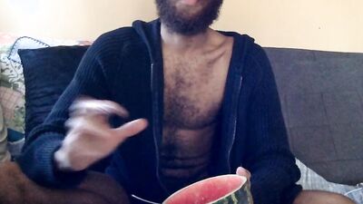 Hairy guy eats a watermelon wearing nothing but sexy robes