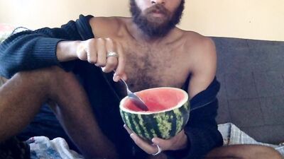 Hairy guy eats a watermelon wearing nothing but sexy robes