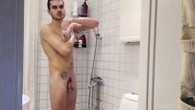 Dashing stud jerks off to porn and takes a shower