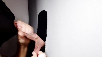 Gimp sucks a hard cock and deepthroats on it through a gloryhole.