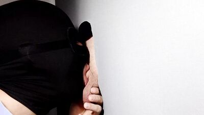 Gimp sucks a hard cock and deepthroats on it through a gloryhole.