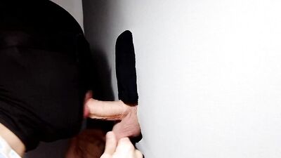 Gimp sucks a hard cock and deepthroats on it through a gloryhole.