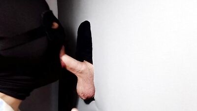 Gimp sucks a hard cock and deepthroats on it through a gloryhole.