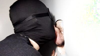 Masked man takes a cock in his mouth and sucks it nicely