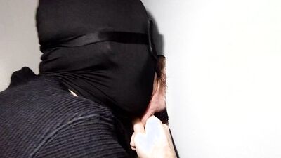 Masked man takes a cock in his mouth and sucks it nicely