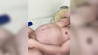Fat guy is rubbed with oil while playing with his dick