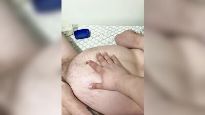 Fat guy is rubbed with oil while playing with his dick