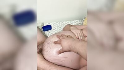 Fat guy is rubbed with oil while playing with his dick