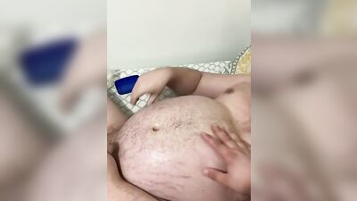 Fat guy is rubbed with oil while playing with his dick