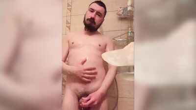 Bearded guy takes a really hot shower