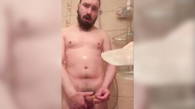 Bearded guy takes a really hot shower