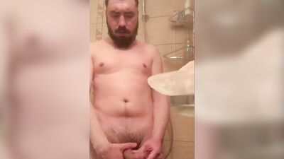 Bearded guy takes a really hot shower