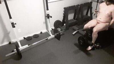 Kinky chubby guy strips naked and exercises in the gym