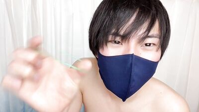 Masked Asian guy is playing with his nipples in front of the webcam