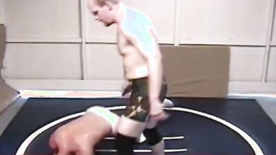 Two gay lads are wrestling half naked on the floor