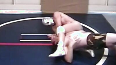 Two gay lads are wrestling half naked on the floor