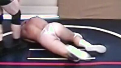Two gay lads are wrestling half naked on the floor