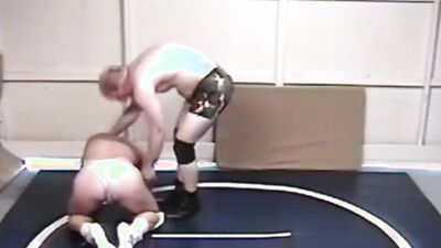 Two gay lads are wrestling half naked on the floor