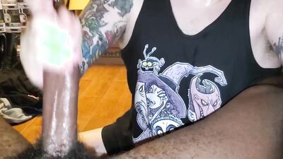 Tattooed white dude slobbers on a big black cock POV