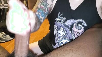Tattooed white dude slobbers on a big black cock POV