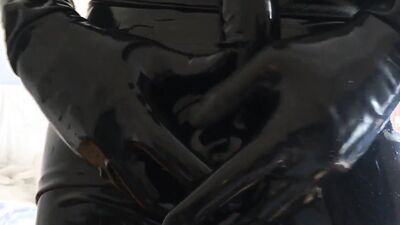 Perverted dude in a latex bodysuit tugs on his big dick