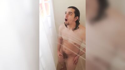 Long-haired guy takes a shower and plays with his pecker