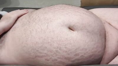 A small-dicked fat man is playing with his belly button